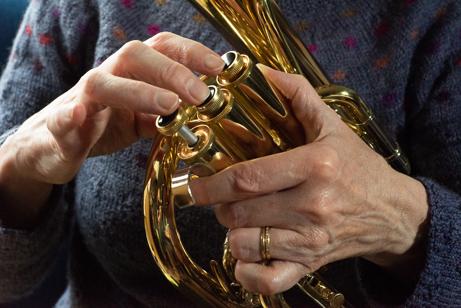 a colour picture of hands playing a tenor horn